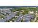 Expansive aerial view of a residential neighborhood with tree-lined streets and community recreational facilities at 704 Grado Pt, Oviedo, FL 32765