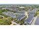 Beautiful aerial view of gray and blue townhomes with sidewalks and street parking at 704 Grado Pt, Oviedo, FL 32765