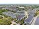 Beautiful aerial view of gray and blue townhomes with sidewalks and street parking at 704 Grado Pt, Oviedo, FL 32765