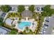 Detailed aerial view of the community pool, lush landscaping, and ample parking spaces at 704 Grado Pt, Oviedo, FL 32765