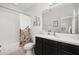 Bathroom featuring a tub and shower, vanity with solid surface counters, and decorative mirror at 704 Grado Pt, Oviedo, FL 32765