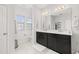 Bright bathroom with double vanity, a large mirror, and modern fixtures at 704 Grado Pt, Oviedo, FL 32765