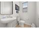 Well-lit bathroom with modern fixtures, pedestal sink, and bidet toilet at 704 Grado Pt, Oviedo, FL 32765