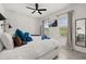 Bedroom featuring a large bed, TV, and plenty of natural light from two windows at 704 Grado Pt, Oviedo, FL 32765
