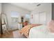 Bedroom showcasing a neutral color scheme, desk, and ample natural light from two windows at 704 Grado Pt, Oviedo, FL 32765