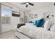 Bedroom featuring a large bed, TV, and plenty of natural light from two windows at 704 Grado Pt, Oviedo, FL 32765