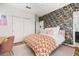 Bedroom with decorative accent wall, closet, and doorway leading to the bathroom at 704 Grado Pt, Oviedo, FL 32765