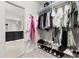 Walk-in closet leading to the bathroom, featuring organized storage and well-lit space at 704 Grado Pt, Oviedo, FL 32765