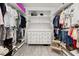 Walk-in closet with ample shelving, hanging space, and a central dresser for optimal storage at 704 Grado Pt, Oviedo, FL 32765
