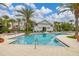 Community pool featuring palm trees, lounge chairs and a clubhouse at 704 Grado Pt, Oviedo, FL 32765