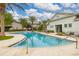 Community pool featuring palm trees, lounge chairs and a clubhouse at 704 Grado Pt, Oviedo, FL 32765