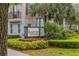 A sign for The Hamptons Townhomes with palm trees in the background at 704 Grado Pt, Oviedo, FL 32765