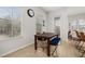 Cozy dining area with wood table, bench seating, a door to the outside, and bright natural light at 704 Grado Pt, Oviedo, FL 32765