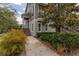 Inviting townhome showcasing well-maintained landscaping and a welcoming entrance, ideal for modern living at 704 Grado Pt, Oviedo, FL 32765