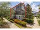 Charming townhome with a landscaped front yard and a balcony, showcasing its inviting curb appeal at 704 Grado Pt, Oviedo, FL 32765