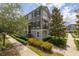 Charming townhome with a landscaped front yard and a balcony, showcasing its inviting curb appeal at 704 Grado Pt, Oviedo, FL 32765