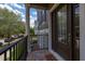 Inviting front porch with stone pavers and views of street and greenery, leading to a paneled front door at 704 Grado Pt, Oviedo, FL 32765