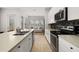 Bright kitchen featuring stainless appliances, stone countertops, and an adjacent living area with lots of natural light at 704 Grado Pt, Oviedo, FL 32765