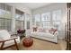 Sun-filled living room with large windows, a comfortable couch, and stylish decor at 704 Grado Pt, Oviedo, FL 32765