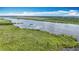 Scenic aerial view of a wide river surrounded by green landscapes and blue sky at 7374 Circle Dr, Lady Lake, FL 32159