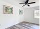 Bedroom featuring wood-look flooring and two decorative paintings at 7374 Circle Dr, Lady Lake, FL 32159