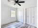 Bedroom with a ceiling fan, closet doors, and a window at 7374 Circle Dr, Lady Lake, FL 32159