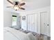 This bedroom has wood-look floors and closet doors at 7374 Circle Dr, Lady Lake, FL 32159