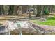 A concrete boat ramp extends into the water, surrounded by lush greenery and trees at 7374 Circle Dr, Lady Lake, FL 32159