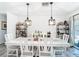 Bright dining room with pendant lighting, open shelving, and a long white table at 7374 Circle Dr, Lady Lake, FL 32159