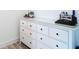 Elegant white dresser with black pulls and glass top at 7374 Circle Dr, Lady Lake, FL 32159
