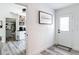 Welcoming entryway showcasing clean lines, a modern farmhouse sign, and a view of the pantry at 7374 Circle Dr, Lady Lake, FL 32159