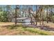 A single-story house with a two car garage sits amidst lush greenery and trees at 7374 Circle Dr, Lady Lake, FL 32159