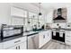 Modern kitchen features stainless steel appliances, a large window with bright countertops and white cabinets at 7374 Circle Dr, Lady Lake, FL 32159