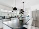 Bright kitchen featuring an island with black marble countertops, white cabinets, and stainless steel appliances at 7374 Circle Dr, Lady Lake, FL 32159