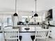 Bright modern kitchen with pendant lights, island and stainless steel appliances at 7374 Circle Dr, Lady Lake, FL 32159
