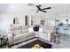 Cozy living room with a modern sectional, dark wood accents, and a large window with natural light at 7374 Circle Dr, Lady Lake, FL 32159