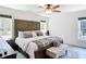 The main bedroom includes a ceiling fan and a decorative, barn-door-style headboard at 7374 Circle Dr, Lady Lake, FL 32159