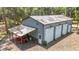 This outbuilding has multiple bays and a covered area for parking equipment at 7374 Circle Dr, Lady Lake, FL 32159