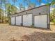 A metal outbuilding with multiple garage bays and clean surroundings at 7374 Circle Dr, Lady Lake, FL 32159