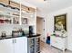 Well-organized pantry with open shelving, marble countertop, wine fridge, and natural light at 7374 Circle Dr, Lady Lake, FL 32159