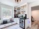 Well-organized pantry featuring open shelving, marble countertops, mini fridge, and ample storage at 7374 Circle Dr, Lady Lake, FL 32159