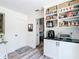 Pantry boasts white cabinets and black marble countertops, complete with shelves for efficient storage and appliances at 7374 Circle Dr, Lady Lake, FL 32159