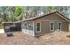 The rear exterior shows the home, yard, and screened-in porch with hot tub at 7374 Circle Dr, Lady Lake, FL 32159