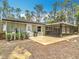 The rear exterior showcases a screened-in porch, patio, and green surroundings at 7374 Circle Dr, Lady Lake, FL 32159