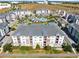 Aerial view of the community featuring multiple residential buildings, green spaces, and a pool area at 7565 Laureate Blvd # 3408, Orlando, FL 32827