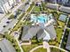 The aerial view captures the layout of community features, including a pool, tennis court, park, and a fire pit area at 7565 Laureate Blvd # 3408, Orlando, FL 32827
