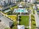 A comprehensive aerial view captures a swimming pool, playground, common areas and tennis court for residents to enjoy at 7565 Laureate Blvd # 3408, Orlando, FL 32827