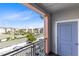 Balcony showcasing community amenities, including a pool, palm trees, and residential buildings at 7565 Laureate Blvd # 3408, Orlando, FL 32827