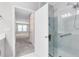 Modern bathroom features a glass-enclosed shower with marble-look tile and accessibility features at 7565 Laureate Blvd # 3408, Orlando, FL 32827