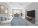Well-lit bedroom with neutral tones, a ceiling fan, large windows, and stylish furnishings at 7565 Laureate Blvd # 3408, Orlando, FL 32827